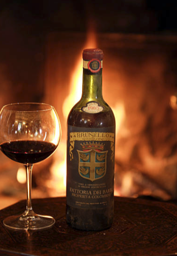 Brunello di Montalcino wine bottle by fireplace, Tuscany